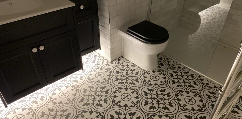 decorative patterned floor tiles and low level lighting bathroom refurb reigate